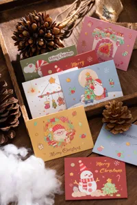 Close-up of assorted colorful Christmas greeting cards with Santa and snowman illustrations