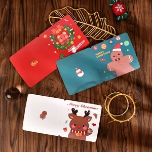 Detailed view of square cartoon Christmas cards with reindeer and gingerbread illustrations.