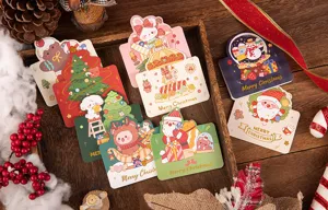 Detailed shot of various gold-stamped Christmas greeting cards with cute cartoon patterns