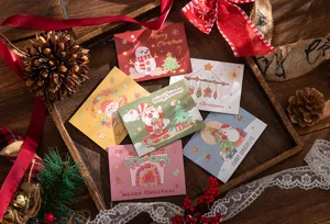 Assorted Christmas tri-fold cards featuring festive snowman and Santa illustrations
