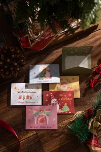 Macro view of various cartoon Christmas greeting cards on a rustic wooden table.