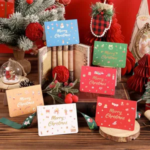Detailed view of assorted colorful Christmas greeting cards with gold foil lettering