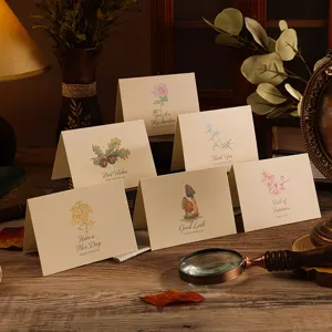 Vintage floral folded greeting cards with elegant illustrations and warm ambient lighting