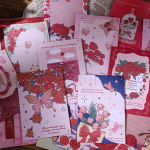 Close-up of vintage oil painting style stationery set with floral and butterfly motifs
