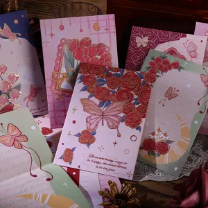 Detail view of vintage oil painting style floral envelopes with gold foil butterfly accents