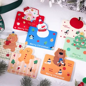 Close-up of cute cartoon Christmas greeting cards with festive holiday designs and messages