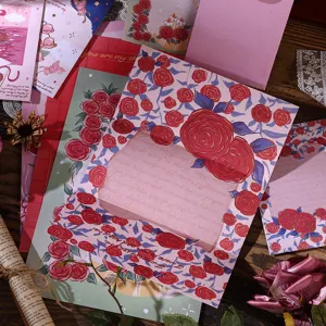 Close-up of vintage oil painting style envelope with red rose patterns and window.