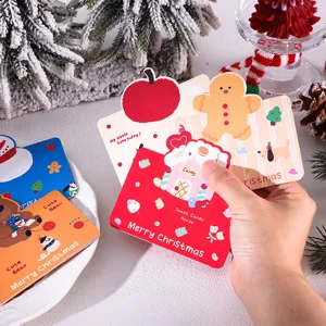 Detailed view of festive Christmas gift cards featuring a cute candy house and gingerbread man