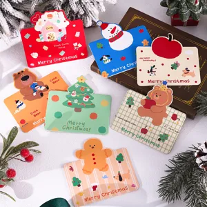 Assorted vintage Christmas gift cards featuring cute gingerbread man and snowman shapes