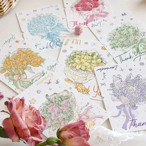 Set di biglietti d'auguri assortiti con mazzi di fiori, messaggi di ringraziamento e nomi.