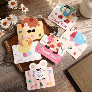 Close-up detail shot of various cute cartoon animal greeting cards on a vintage wooden tray
