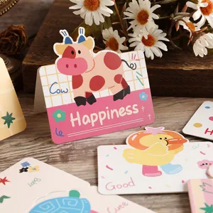 Detail view of cute cartoon animal greeting cards with cow and duck illustrations