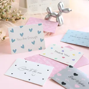 Close-up of assorted aesthetic greeting cards with heart patterns and inspirational quotes