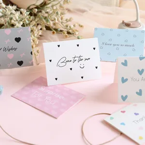 Detailed close-up of colorful minimalist greeting cards with romantic heart patterns