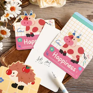 Detailed view of cute cartoon cow and hedgehog greeting cards with handwritten message