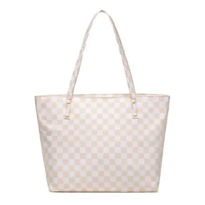 Vista frontal de un bolso tote grande a cuadros crema y blanco con tachuelas doradas