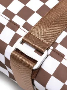 Macro detail view of the durable plastic buckle and strap on a brown and white checkered bag