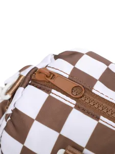 Close-up detail of the durable brown plastic zipper on a checkered travel bag.