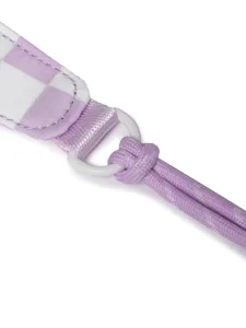 Detail of purple checkered travel bag strap with durable braided cord and white ring