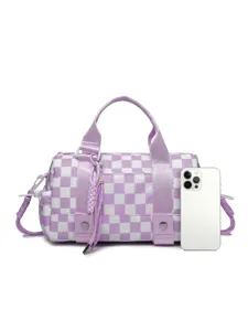 Purple checkered travel duffel bag with handles and shoulder strap shown with phone for scale