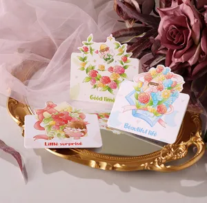 Detailed view of three cartoon floral greeting cards on a gold vintage tray