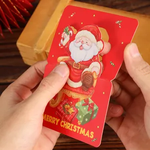 Close-up detail of a vintage red Christmas gift tag held by hands for size showing