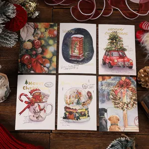 Assorted Christmas greeting cards with elegant gold foil stamping on a festive wooden backdrop