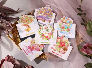 Macro view of colorful cartoon floral greeting cards with English wishes