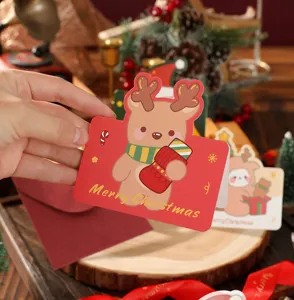 Detail showing a cute bear illustration on a red Merry Christmas greeting card
