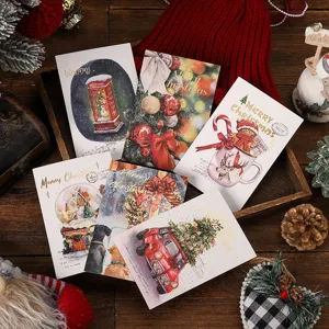 Detailed view of gold foil Christmas greeting cards featuring vintage holiday illustrations
