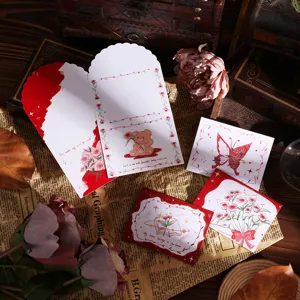 Detailed view of vintage tri-fold greeting cards with elegant floral and bear designs