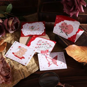 Detail view of retro flower greeting cards arranged with vintage newspapers and roses