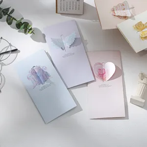 Set of 3D pop-up greeting cards with heart, wings, and ribbon designs in pastel colors