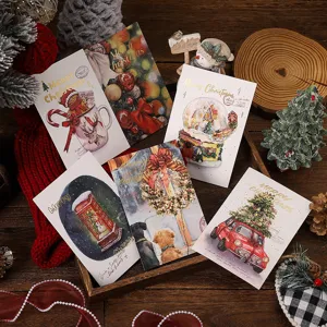 Detail view of various gold-stamped Christmas greeting cards with festive illustrations