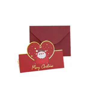 Elegant heart-shaped gold-foil Christmas card featuring Santa Claus with a red envelope