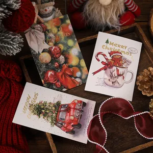 Detailed view of Christmas postcards featuring festive illustrations and gold foil text