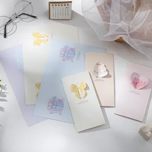 Detailed view of handmade 3D pop-up greeting cards with elegant bow and heart designs.