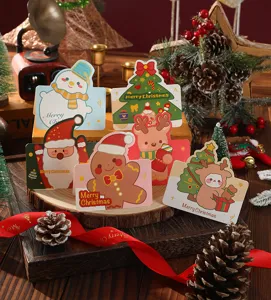 Collection of cute cartoon Christmas greeting cards arranged in a warm festive setting