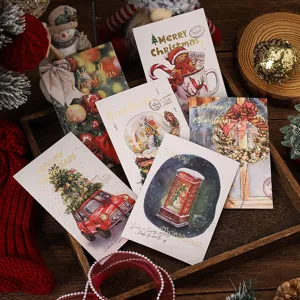 Detailed view of vintage gold-stamping Christmas greeting cards with festive illustrations