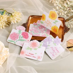 Close-up of floral Mother's Day cards with sunflower and rose designs on a gold tray