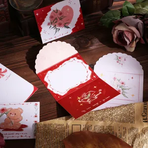 Macro detail of vintage tri-fold greeting cards featuring floral motifs and envelopes