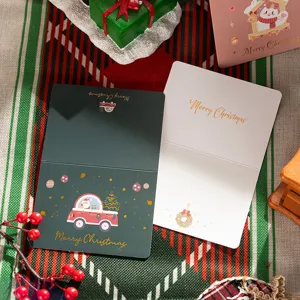 Detailed view of Christmas cards with gold foil lettering and festive illustrations