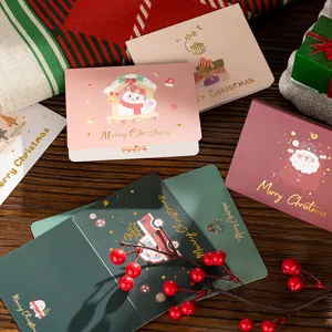 Detail showing gold foil 'Merry Christmas' text and festive motifs on greeting cards