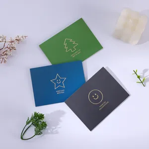 Close-up of minimalist gold-stamped greeting cards in green blue and grey colors