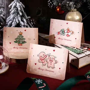 Close-up of vintage Christmas greeting cards featuring cartoon tree and gingerbread men designs.