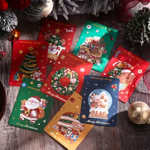 Dettaglio di biglietti di auguri natalizi vintage con lamina d'oro e Babbo Natale
