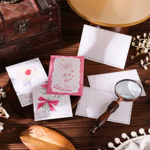 Detailed view of floral postcards and greeting cards with a vintage magnifying glass