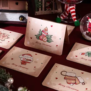 Detailed view of vintage Christmas cards featuring cute snowman and mitten illustrations
