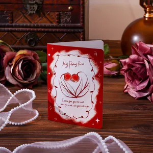 Romantic vintage red rose greeting card on wooden table with pearls and roses.