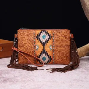 Vista detallada del bolso bandolera boho de cuero tallado con flecos decorativos.